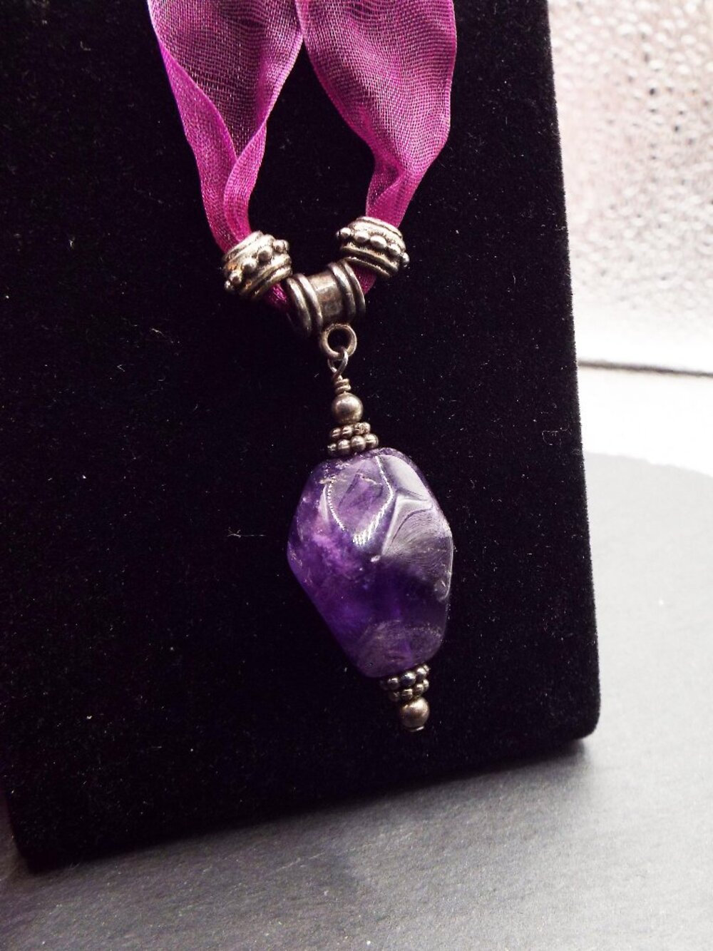 FACETED AMETHYST BIPYRAMID SHAPE PENDANT ON PURPLE RIBBON 42